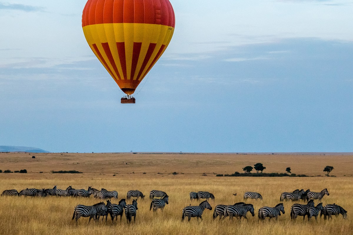 A hot air balloon sails along in Kenya’s Maasai Mara National Reserve