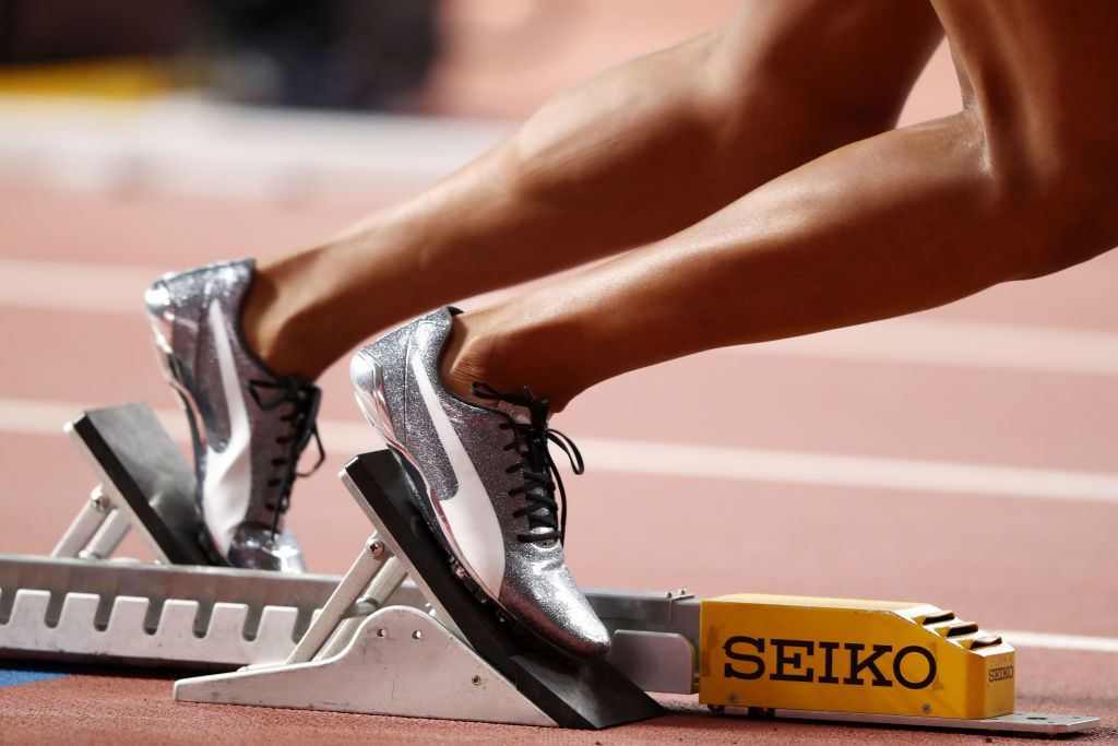 A runner settles into their starting blocks before a race