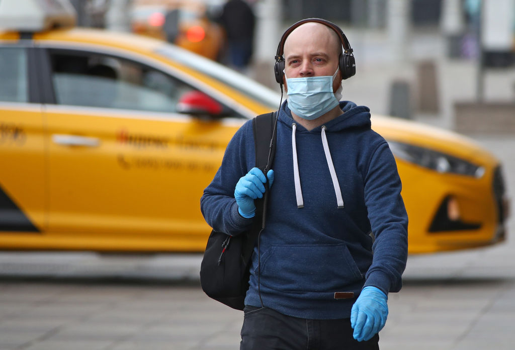 A man walks with a face mask on