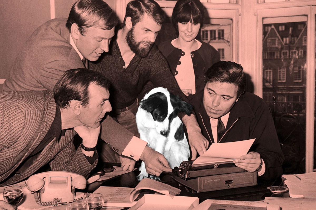 People at work gather around a dog