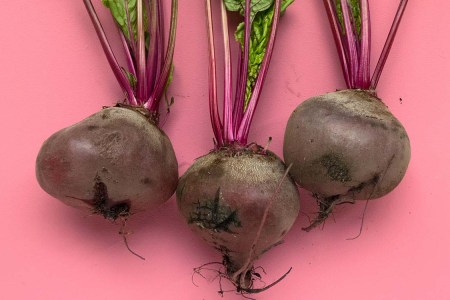 Pictures of beets against a pink background.