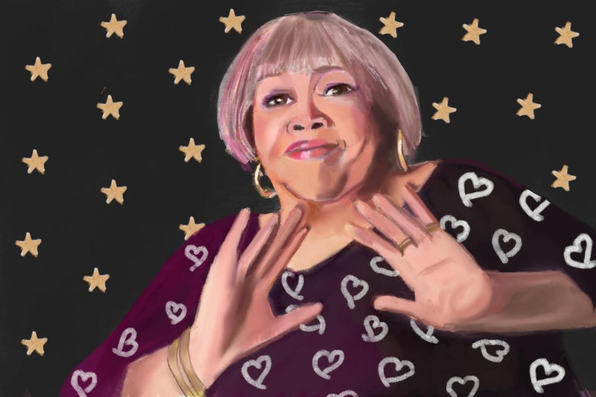 Mavis Staples poses in front of a starry background