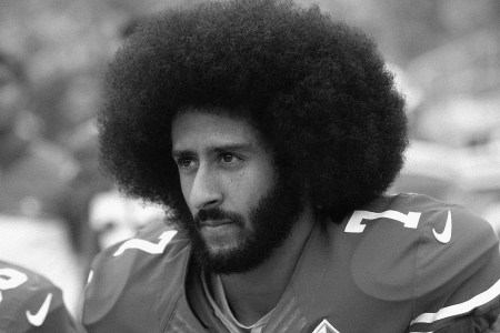 Colin Kaepernick kneels before a game
