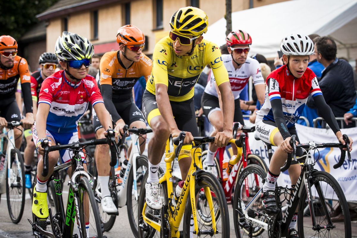 Colombia's Tour de France winner Egan Bernal cycles amidst young local riders on July 31, 2019