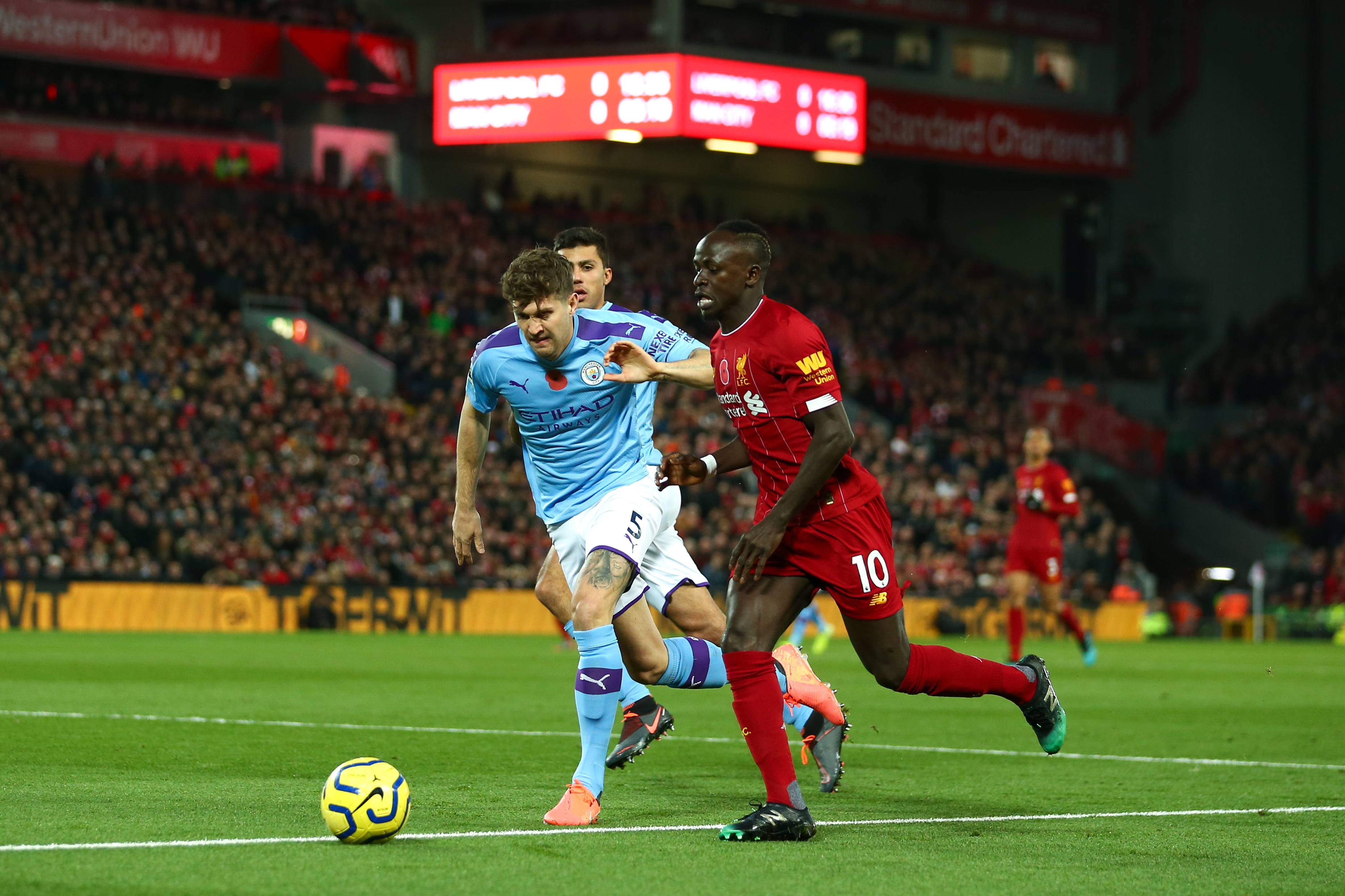 Sadio Mane of Liverpool and John Stones of Manchester City during the Premier League match between Liverpool FC and Manchester City at Anfield on November 10, 2019.