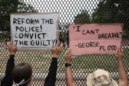 Two people protesting near the White House