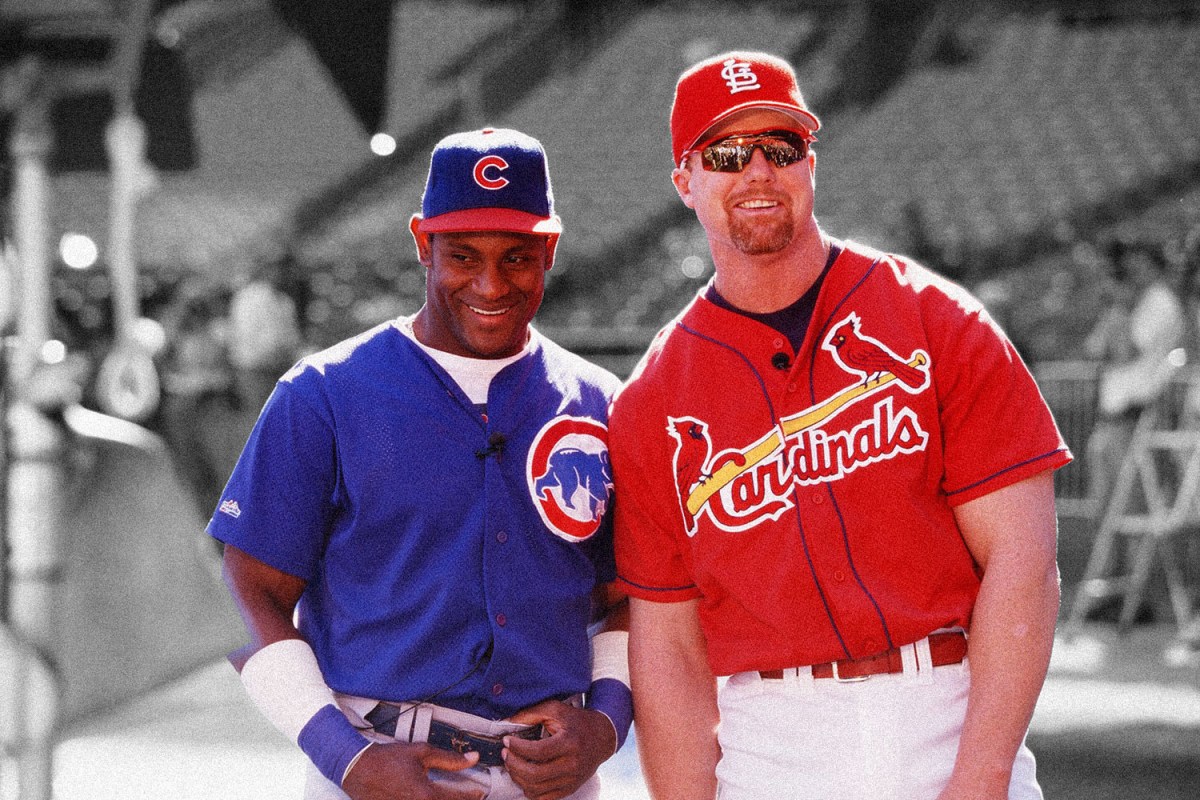 Mark McGwire of the St. Louis Cardinals and Sammy Sosa of the Chicago Cubs joke before the game at Busch Stadium on September 7, 1998 in St. Louis, Missouri. (Photo by Sporting News via Getty Images via Getty Images)