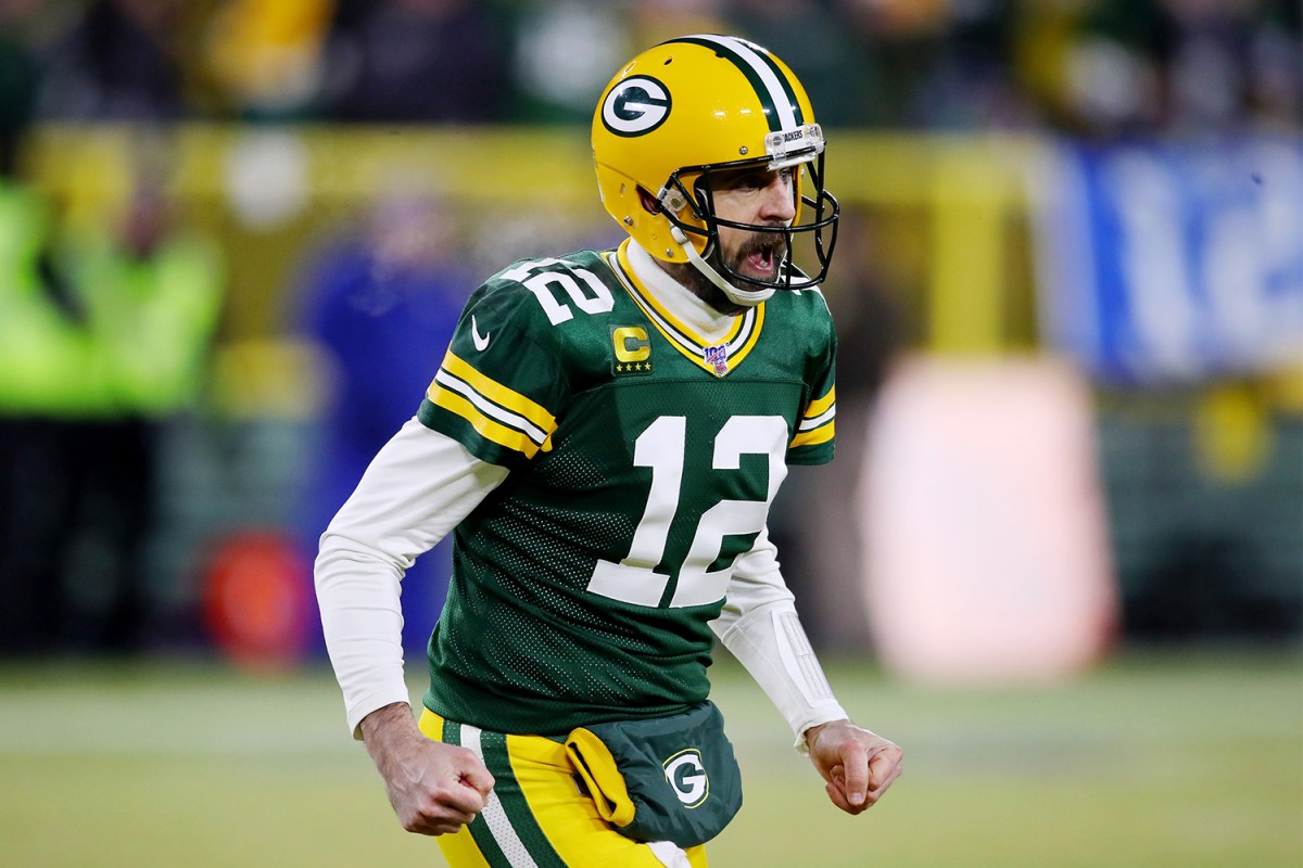 Quarterback Aaron Rodgers Green Bay Packers throws a touchdown pass during the first quarter against the Seattle Seahawks in the NFC Divisional Playoff game at Lambeau Field on January 12, 2020 in Green Bay, Wisconsin
