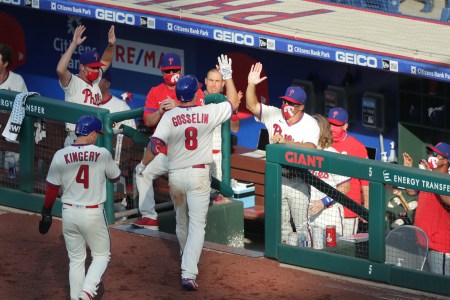 Phil Gosselin of the Philadelphia Phillies high fives manager Joe Girardi after hitting a two-run home run in the sixth inning during a game against the Miami Marlins at Citizens Bank Park on July 25, 2020 in Philadelphia, Pennsylvania. The 2020 season had been postponed since March due to the COVID-19 pandemic. (Photo by Hunter Martin/Getty Images)
