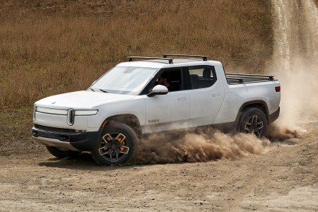 Rivian R1T electric pickup truck driving in the dirt