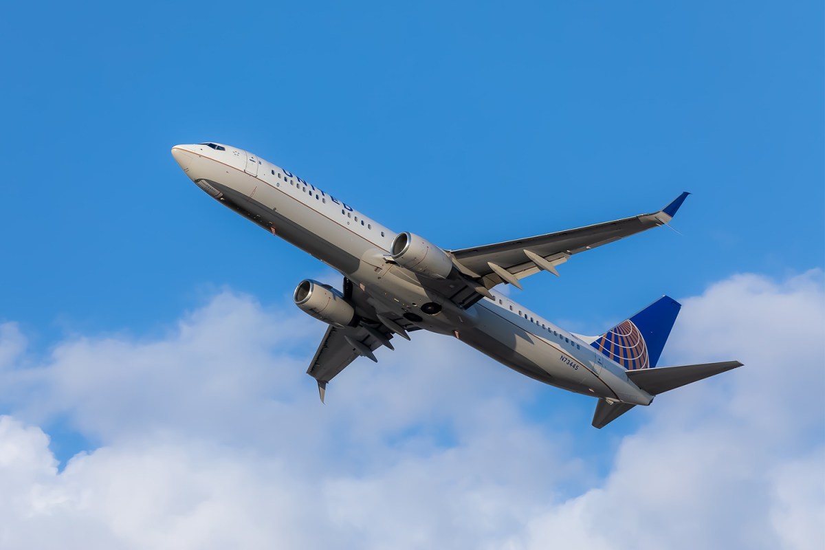 United Airlines airplane flying in a blue sky