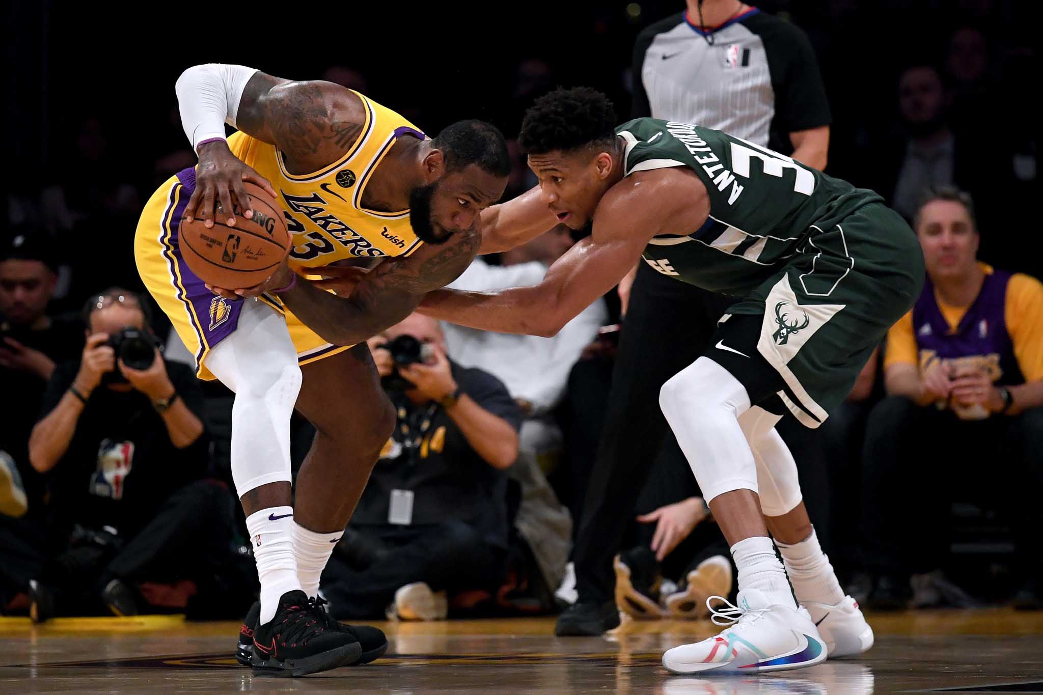 LeBron James is guarded by Giannis Antetokounmpo during the third quarter at Staples Center on March 06, 2020