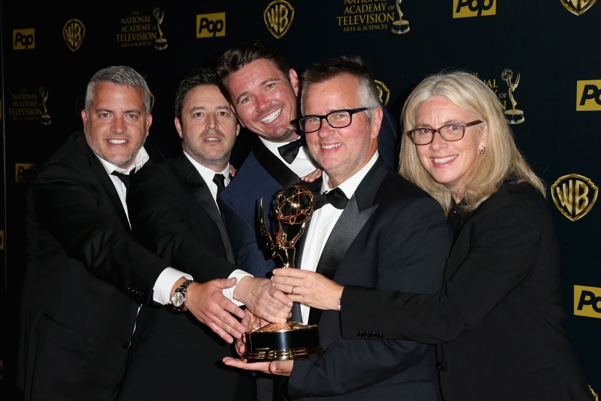 Ellen DeGeneres show executives posing with a Daytime Emmy award