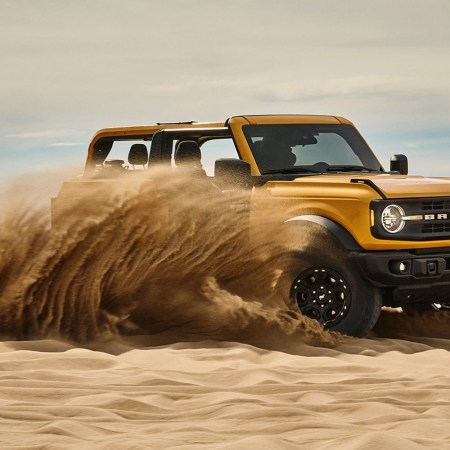 yellow 2021 Ford Bronco SUV driving in the sand