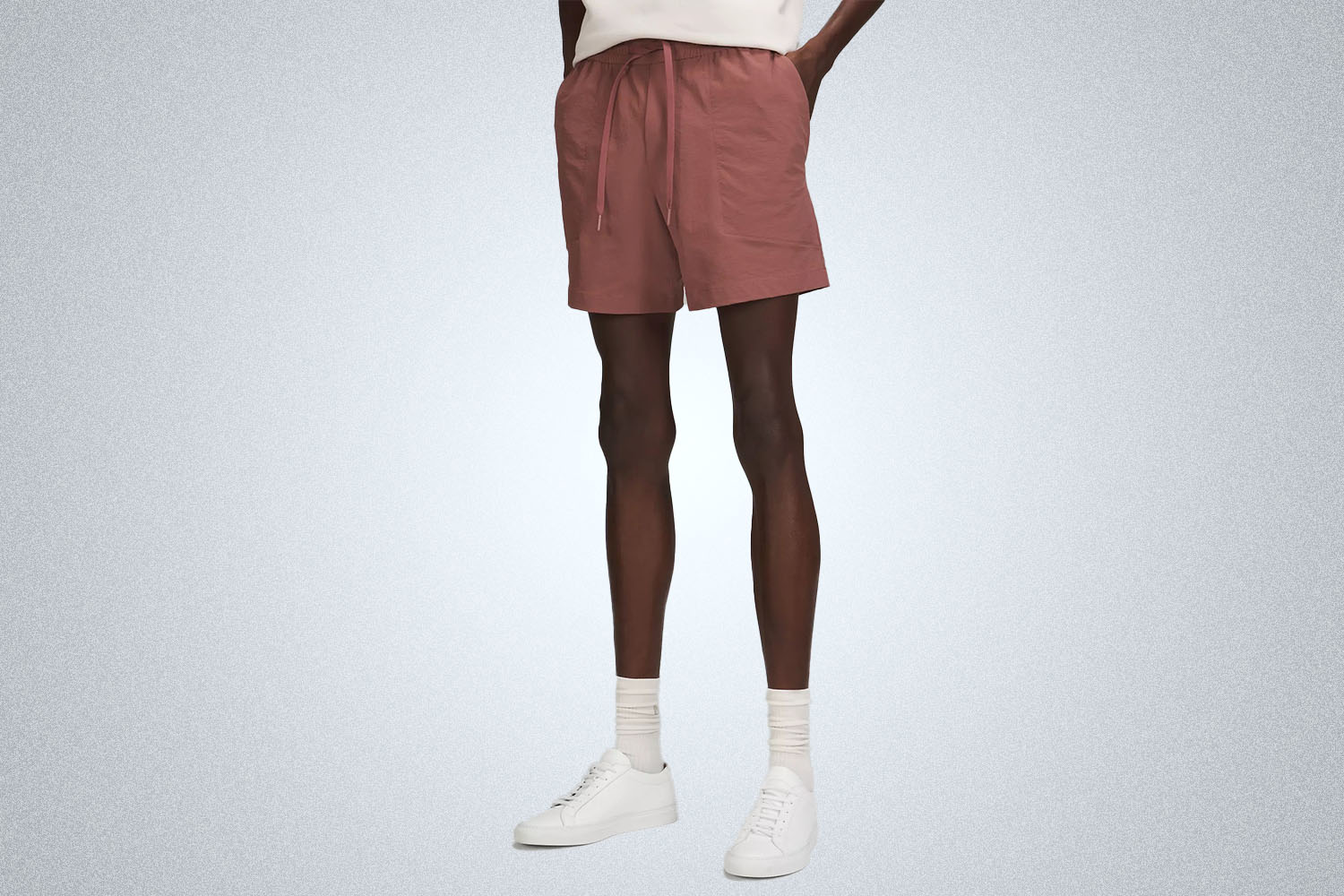 a model in a pair of Lululemon Bowline Shorts on a grey background