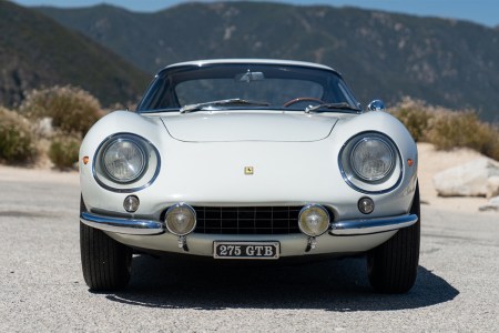 A white 1966 Ferrari 275 GTB Long Nose sitting on the road