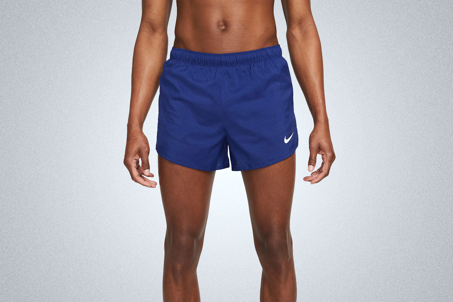 a model in a pair of Nike Fast Shorts on a grey background