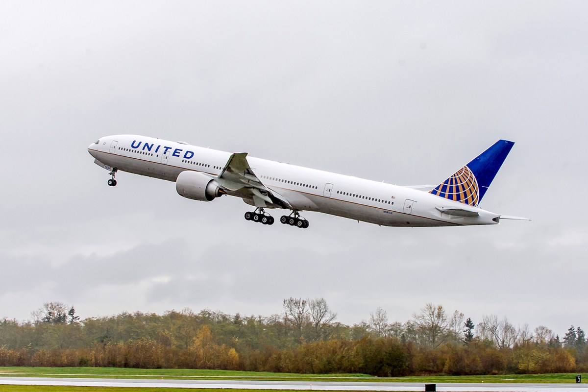 United Airlines Boeing 777-300ER airplane taking off on a runway