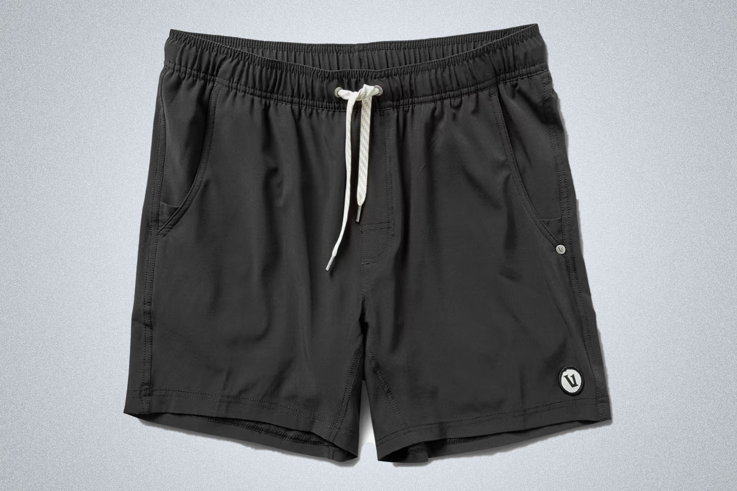 a pair of black Vuori shorts on a grey background