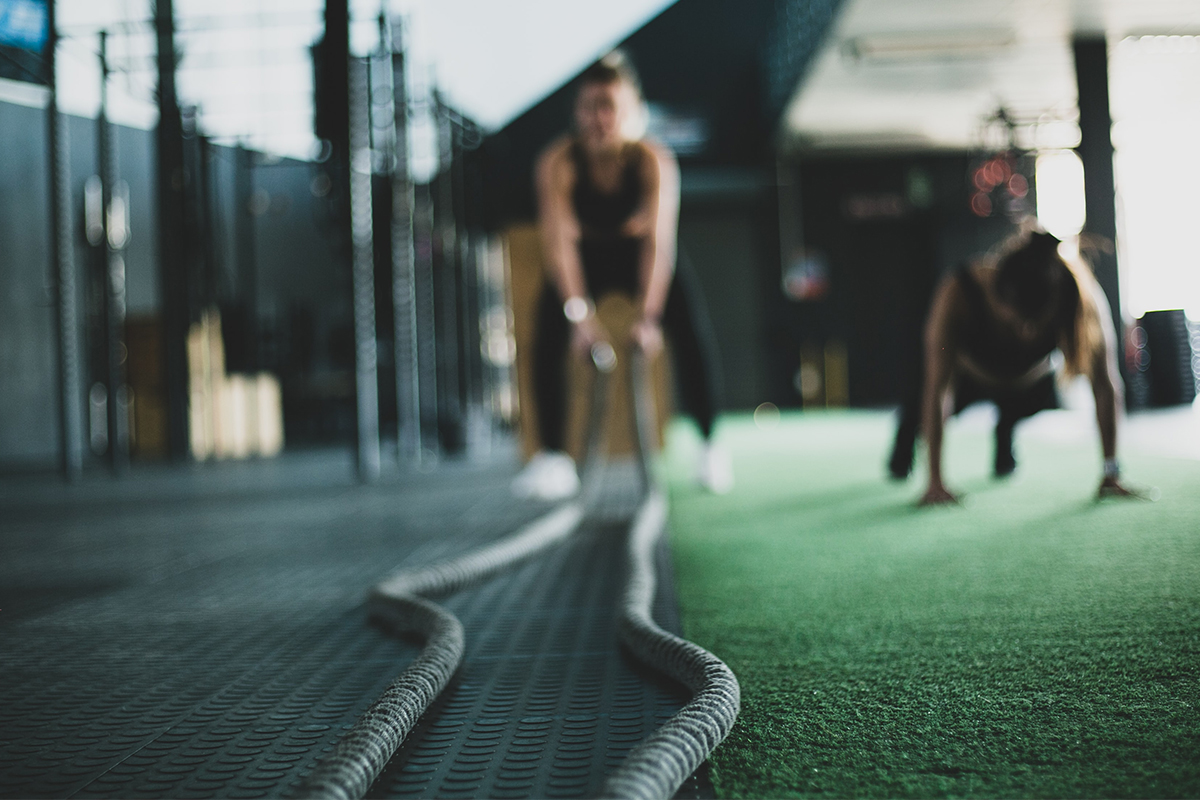 Athlete in the gym holding battle ropes
