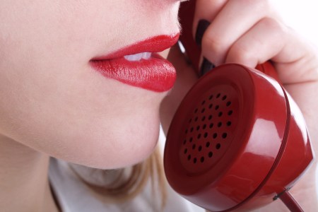 woman with red lipstick talking on the phone