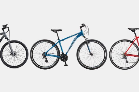 Three bicycles including an electric bike, hybrid bike and road bike