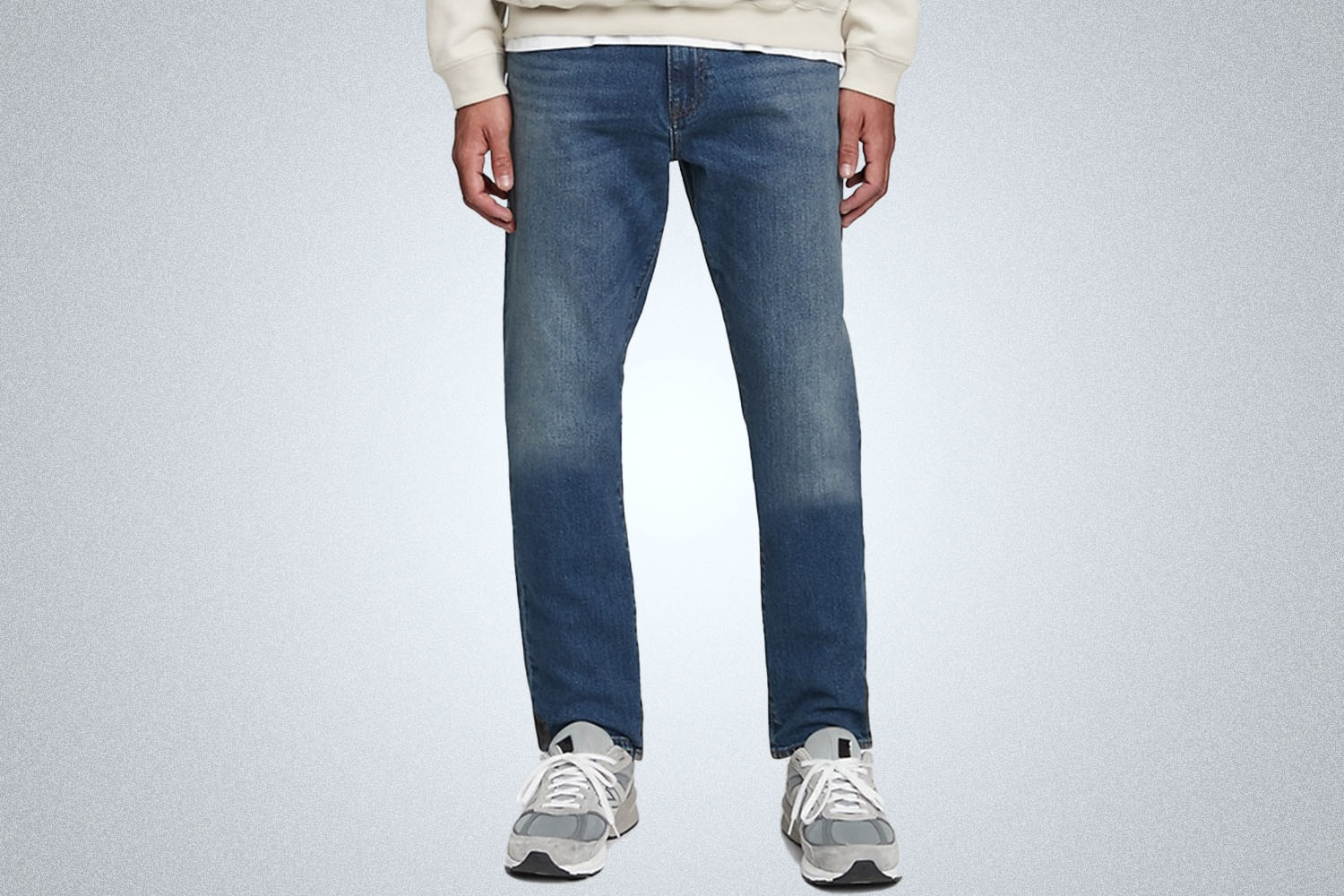 a pair of medium wash jeans on a model