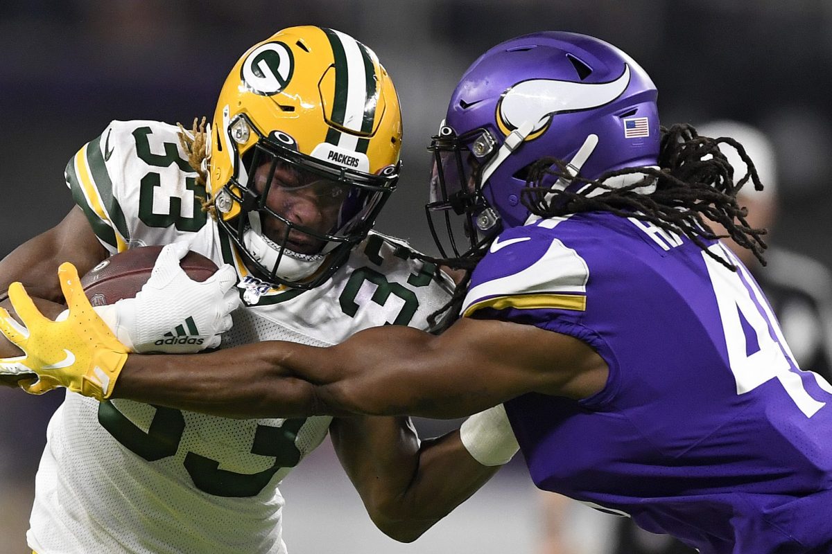 Aaron Jones of the Green Bay Packers carries the ball against defensive back Anthony Harris in 2019.