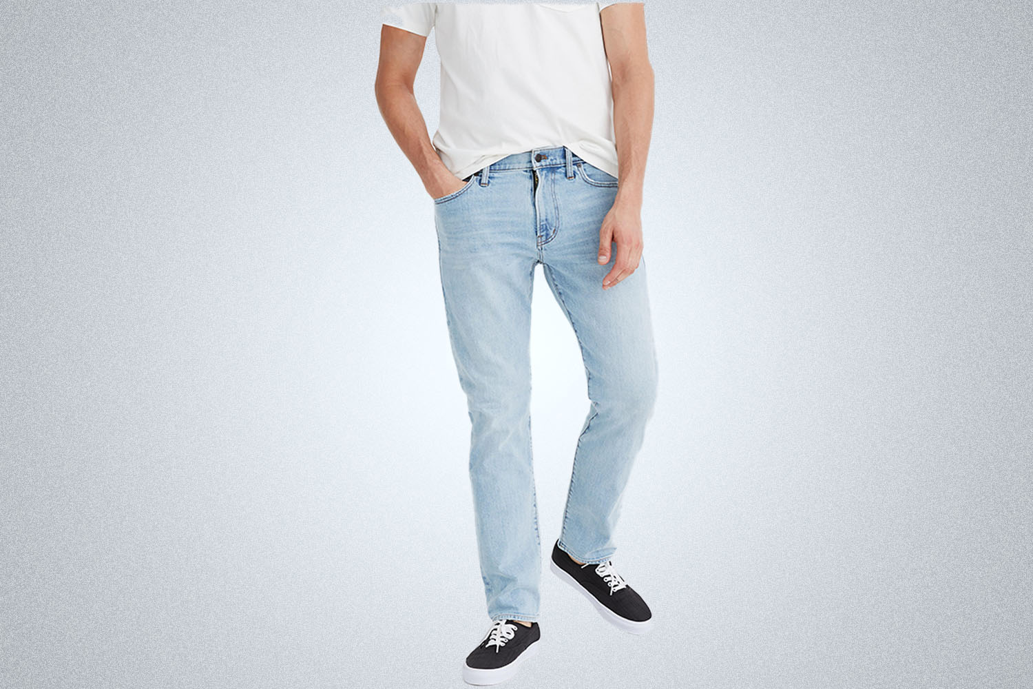 a pair of light wash slim jeans on a model