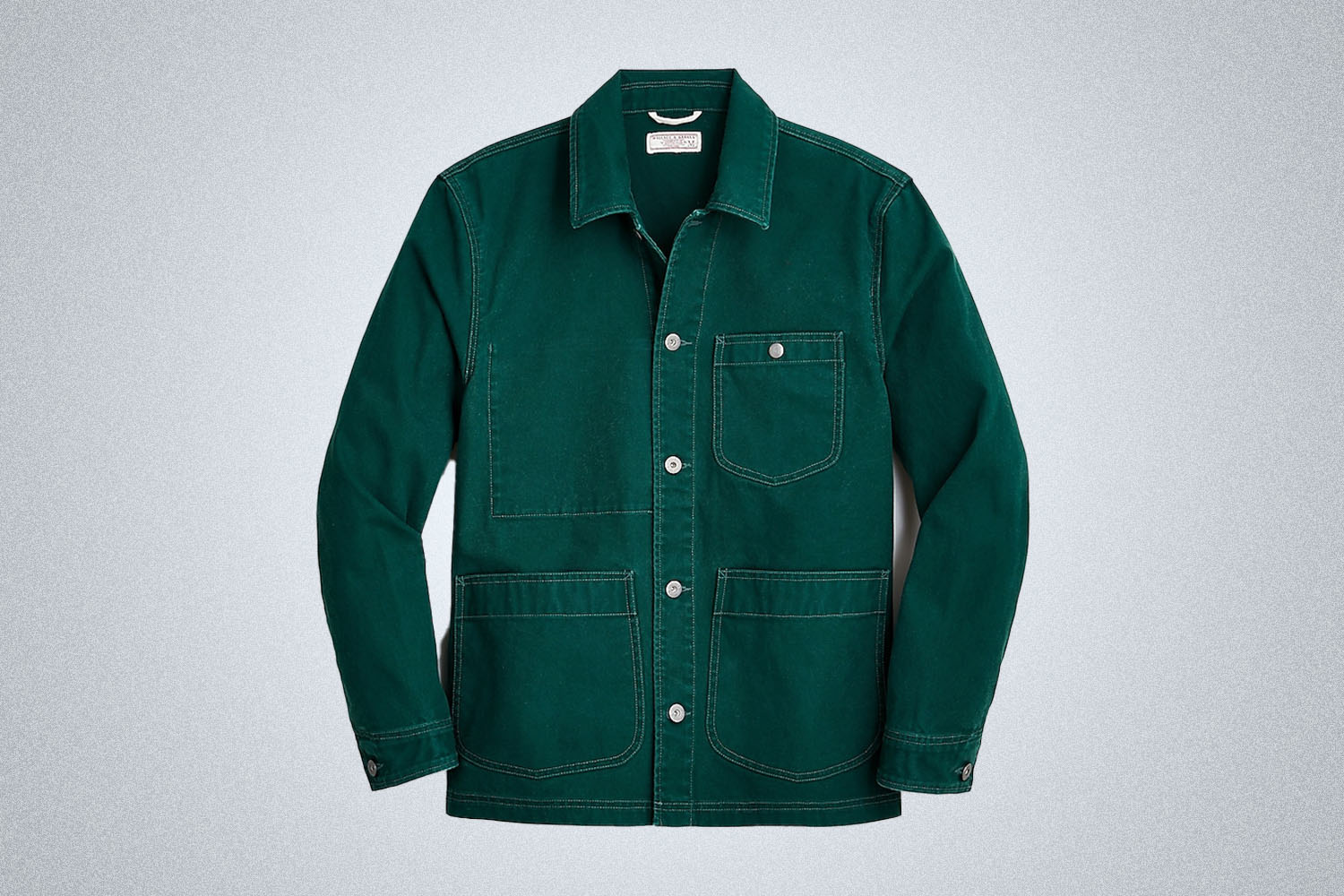 a green Wallace and Barnes Chore Coat on a grey background