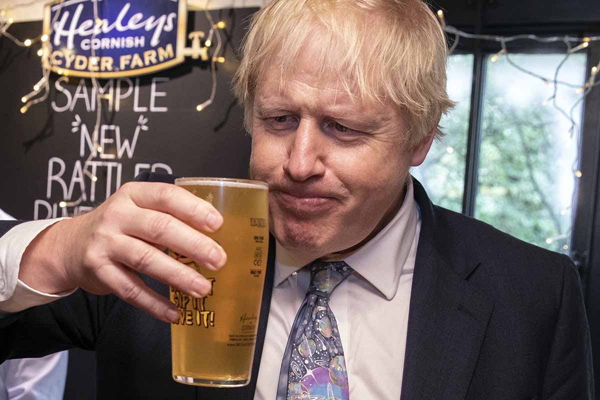 Boris Johnson drinking a beer