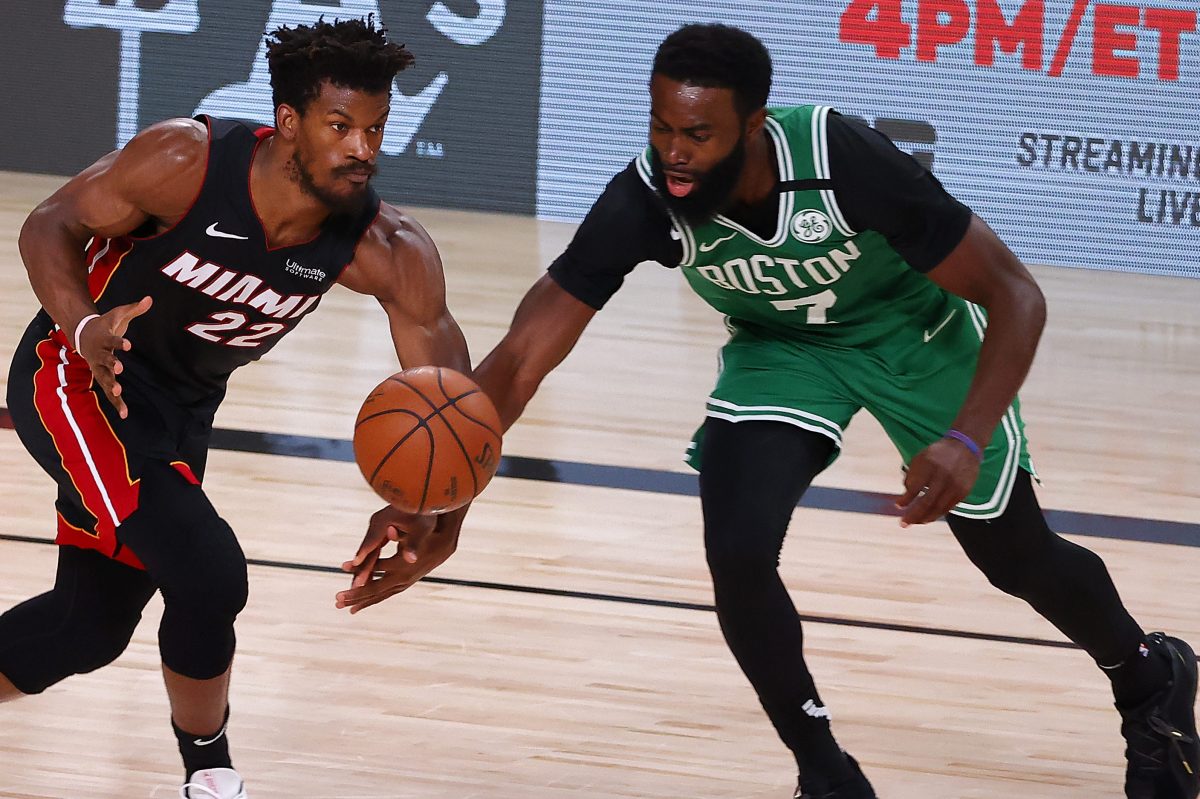 Jimmy Butler of the Miami Heat and Jaylen Brown of the Boston Celtics fight for a loose ball.