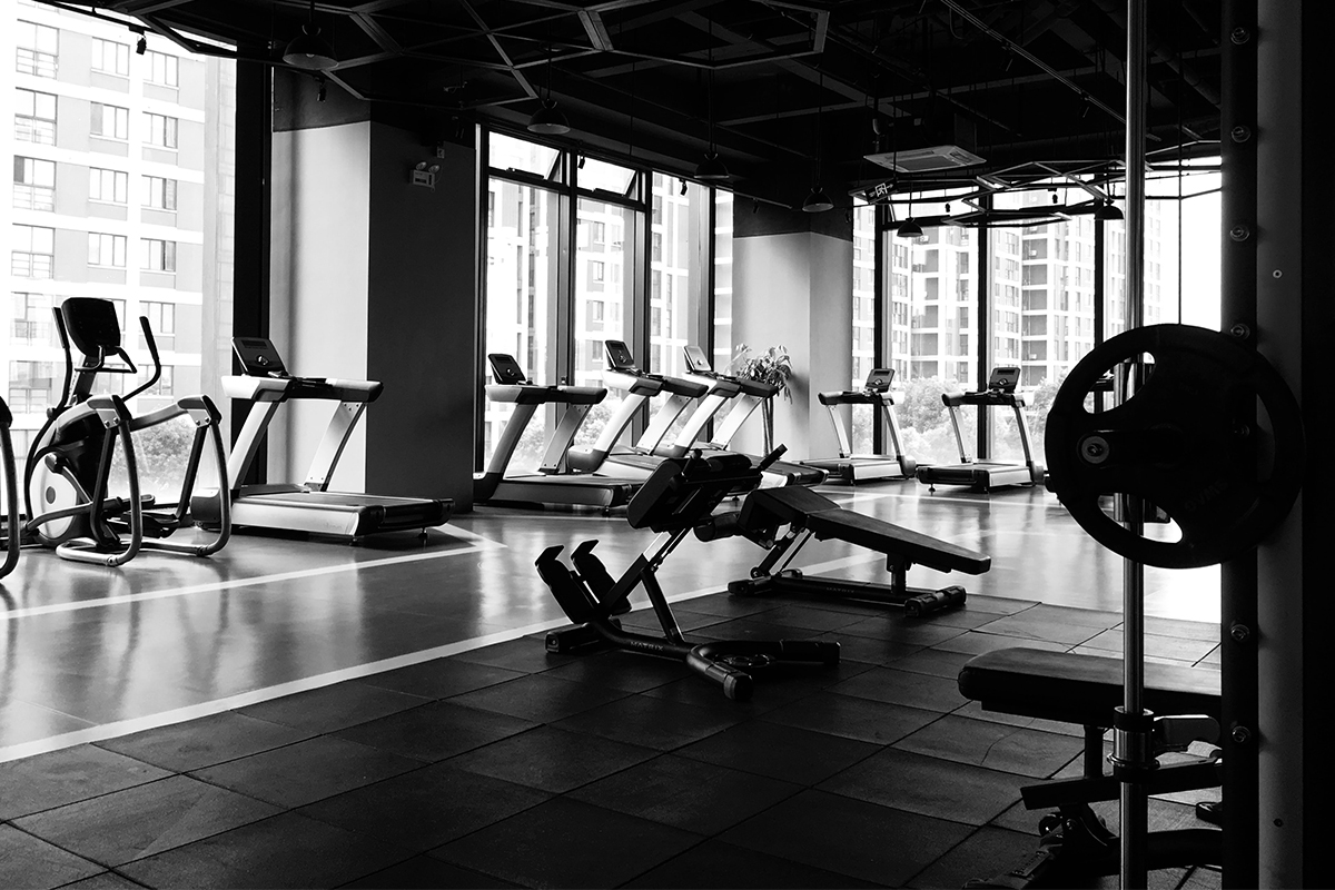 black and white photo of a gym with fitness equipment