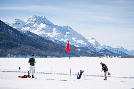 Two golfers playing snow golf at the Engadin Snow Golf Cup in Switzerland