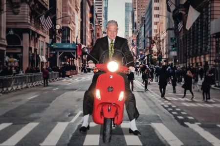 David Letterman riding a Vespa motor scooter in New York City