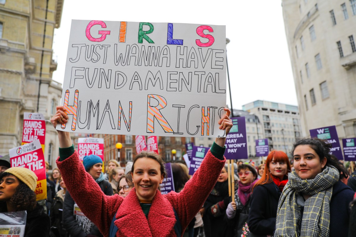 A woman with a sign at the Bread and Roses Women's March on January 19, 2019 in London, England