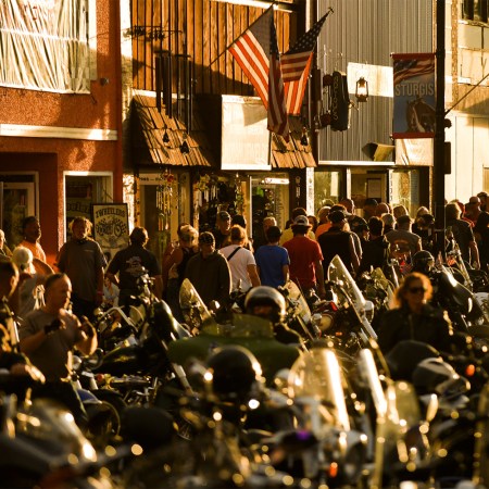 People walk along Main Street during the 80th Annual Sturgis Motorcycle Rally in Sturgis, South Dakota on August 8, 2020