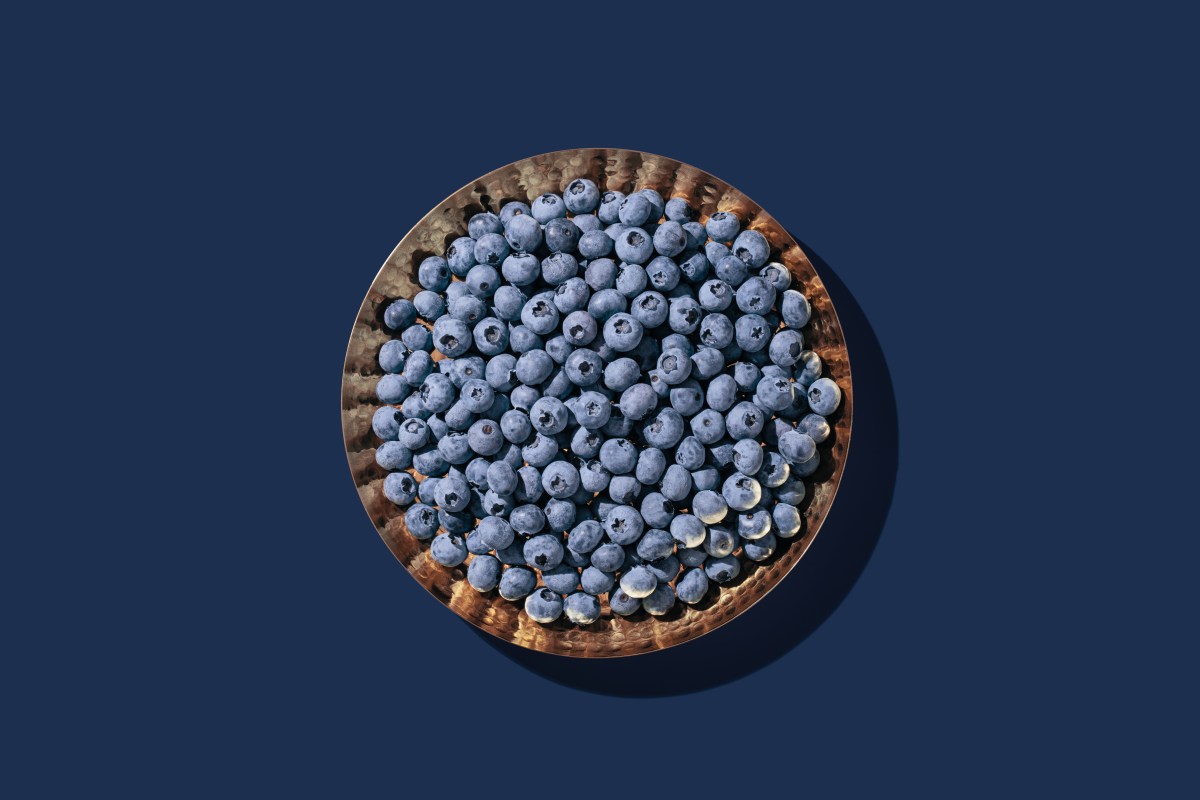 A high angle view of a bowl of blueberries, one of the best foods you can eat to beat morning anxiety