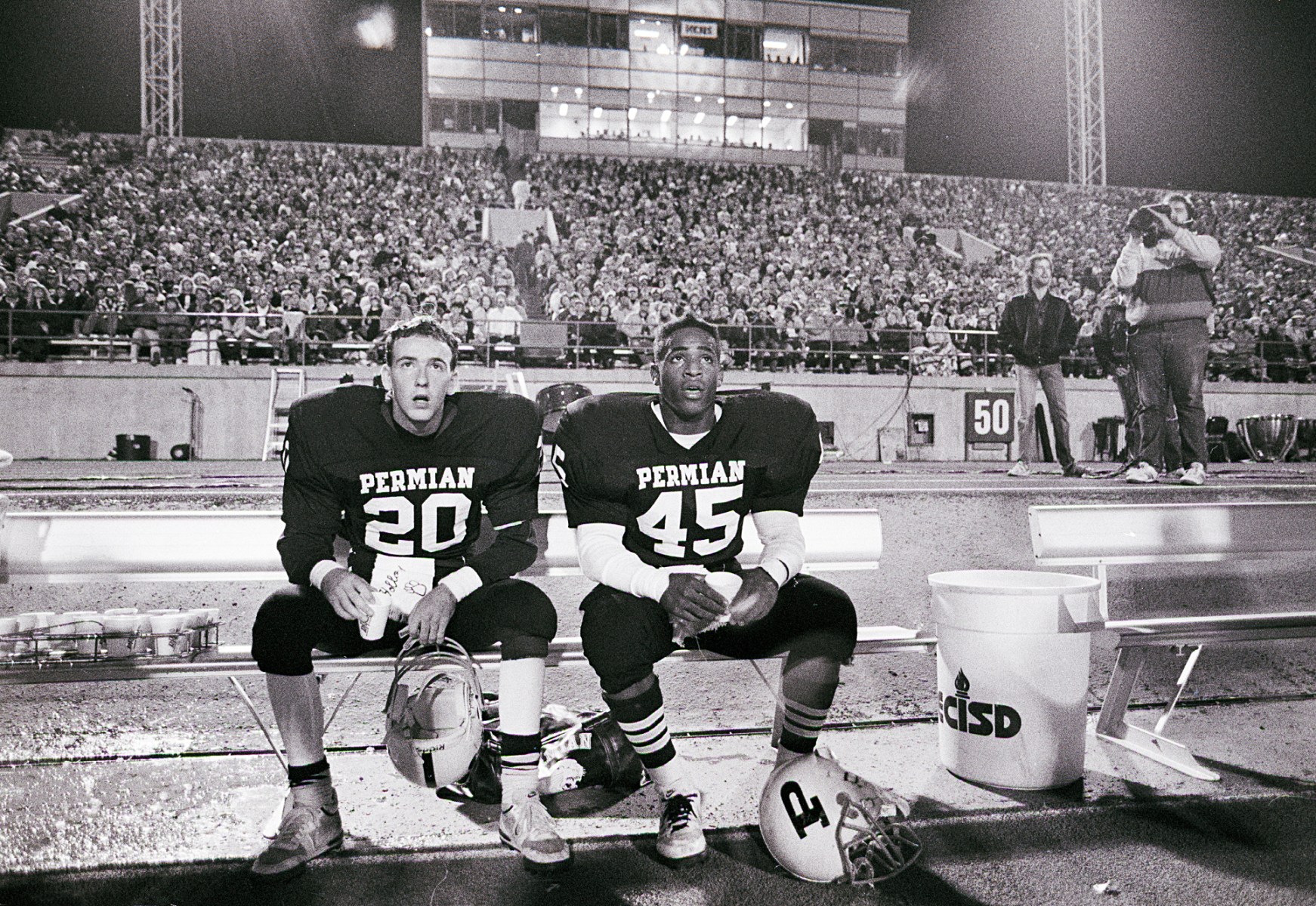 Mike Winchell (20) and Chris Comer (45) sit in stunned silence as they realize a game against Midland Lee is lost and there will be no heroic comeback. Permian entered the night as a 21-point favorite.<br><br>“This was fairly late in the game. Winchell was the quarterback and Comer was the running back,” Clark says. “There's a whole series of them  looking around and then their mouths are kind of agape because of a play they just watched. I wouldn't say they were dejected, but they were a little concerned about where the game was going.”