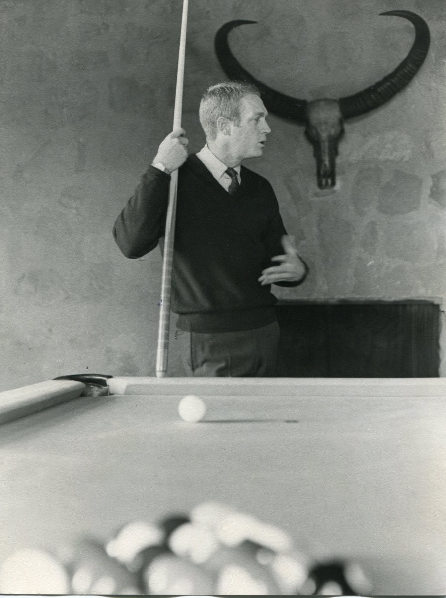 “Here’s McQueen shooting pool inside The Castle, his Spanish-Mediterranean stone mansion in Brentwood, California, just north of Sunset Boulevard,” Terrill says. “His custom pool table was placed in a sunken living room in their 5,560-square-foot house, which he purchased in February 1963. At the time, he said he could barely afford the five-bedroom home, which cost $250,000. Today it is worth more than $10 million."