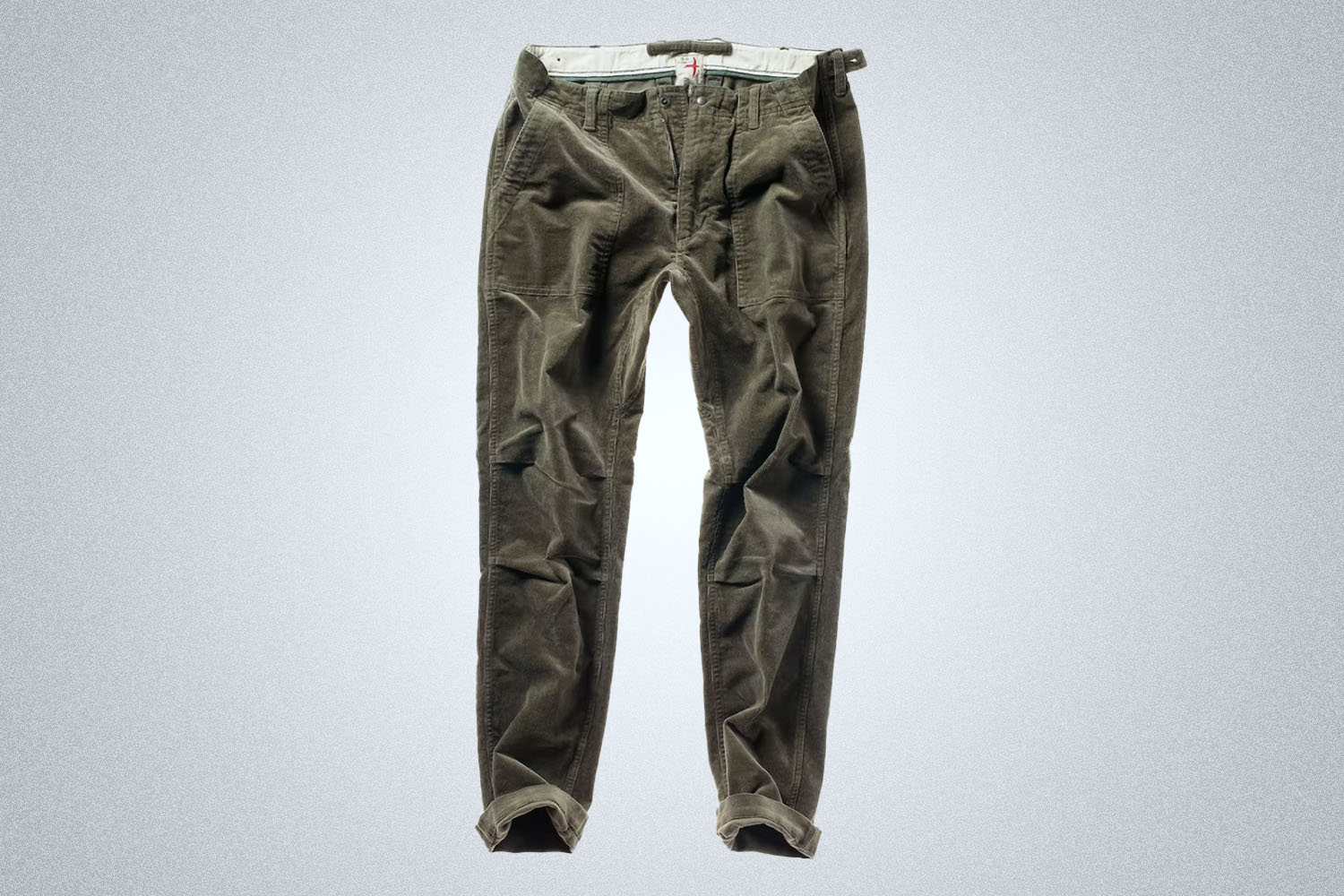 a pair of green Relwen corduroy pants on a grey background