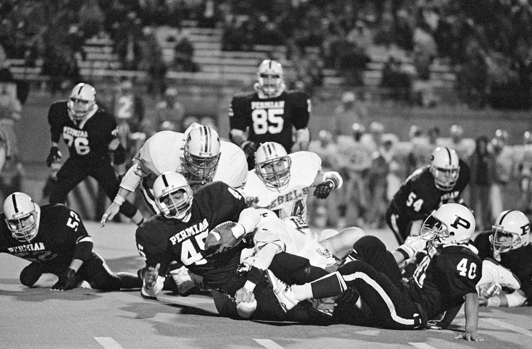 Running back Chris Comer rushes for a first down against the arch-rival Midland Lee Rebels.<br><br>“Comer really became quite the star for them that year,” Clark says. “The next season, he did an amazing job and Permian were state champions. He was a great kid and almost had 4,000 yards rushing in his career. Comer is Permian’s third all-time leading rusher with 3,724 yards in two seasons as starter. That's pretty amazing. He was so good. The really sad thing is, Chris died when he was 46 years old. He went in for an operation and didn't come out. It was a very sad turn of events.”