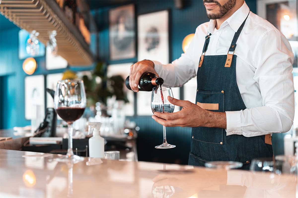 sommelier pouring wine