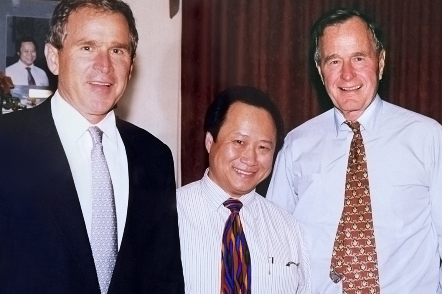 Presidents George Bush and George W. Bush with the owner of Peking Gourmet Inn.