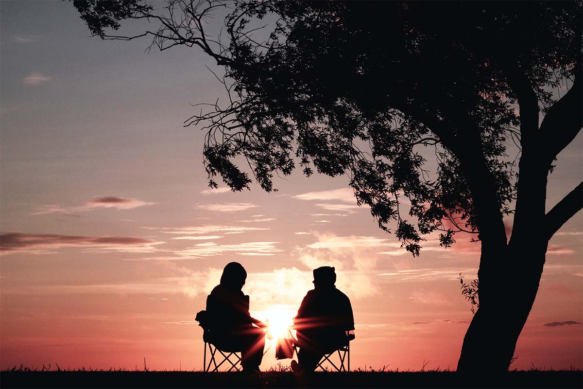 two people watching sunset
