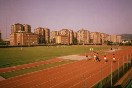 A vintage photo of men running around a track in Italy.
