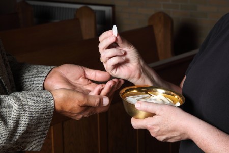 woman serving communion
