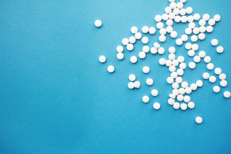 white pills on blue background