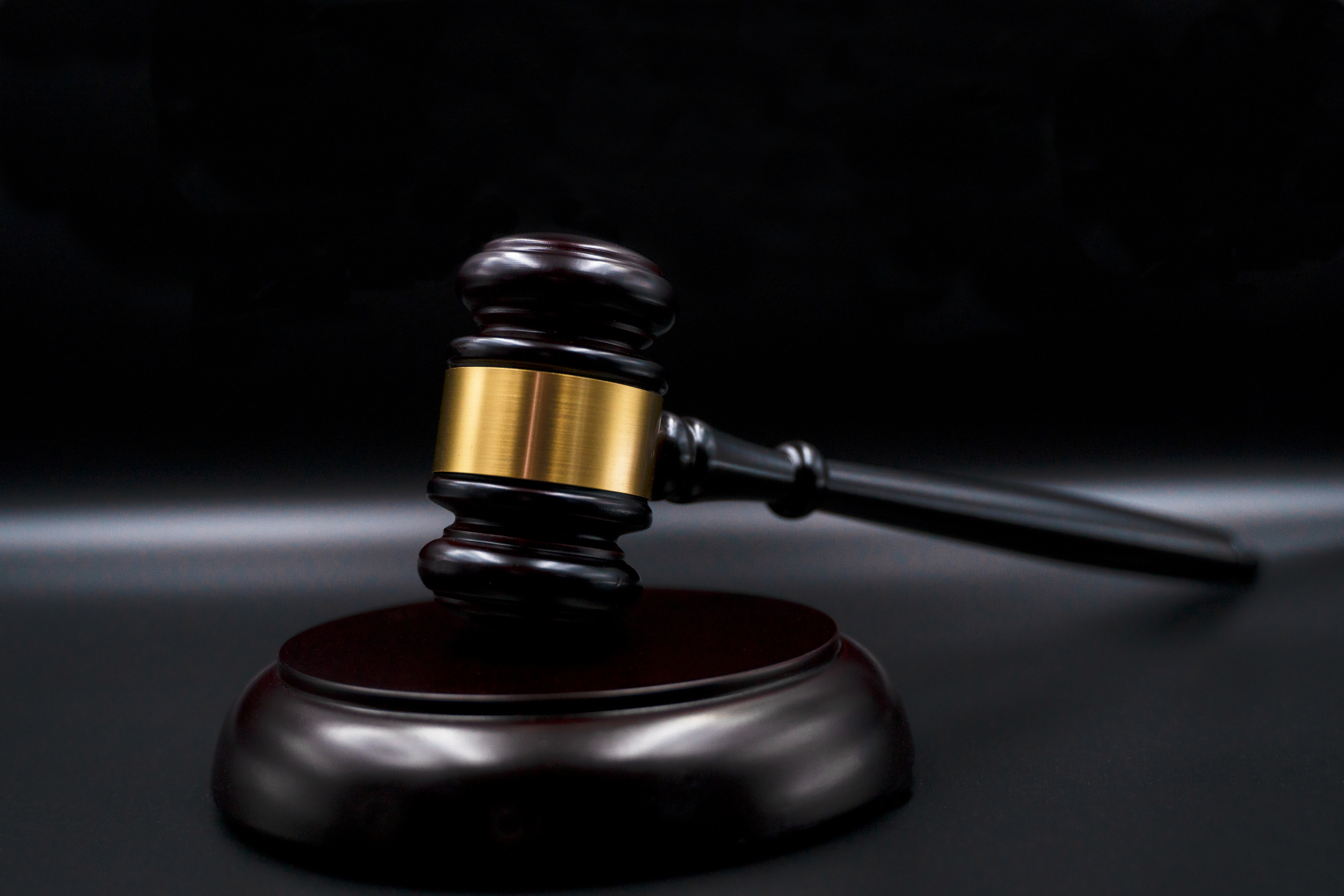 Wooden court gavel on black background