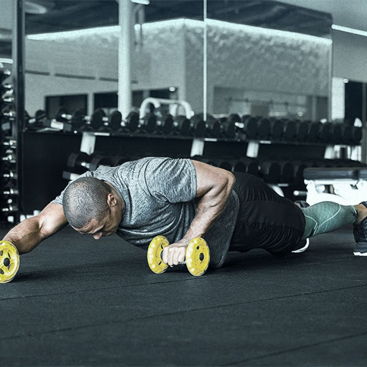 man working out with core wheels